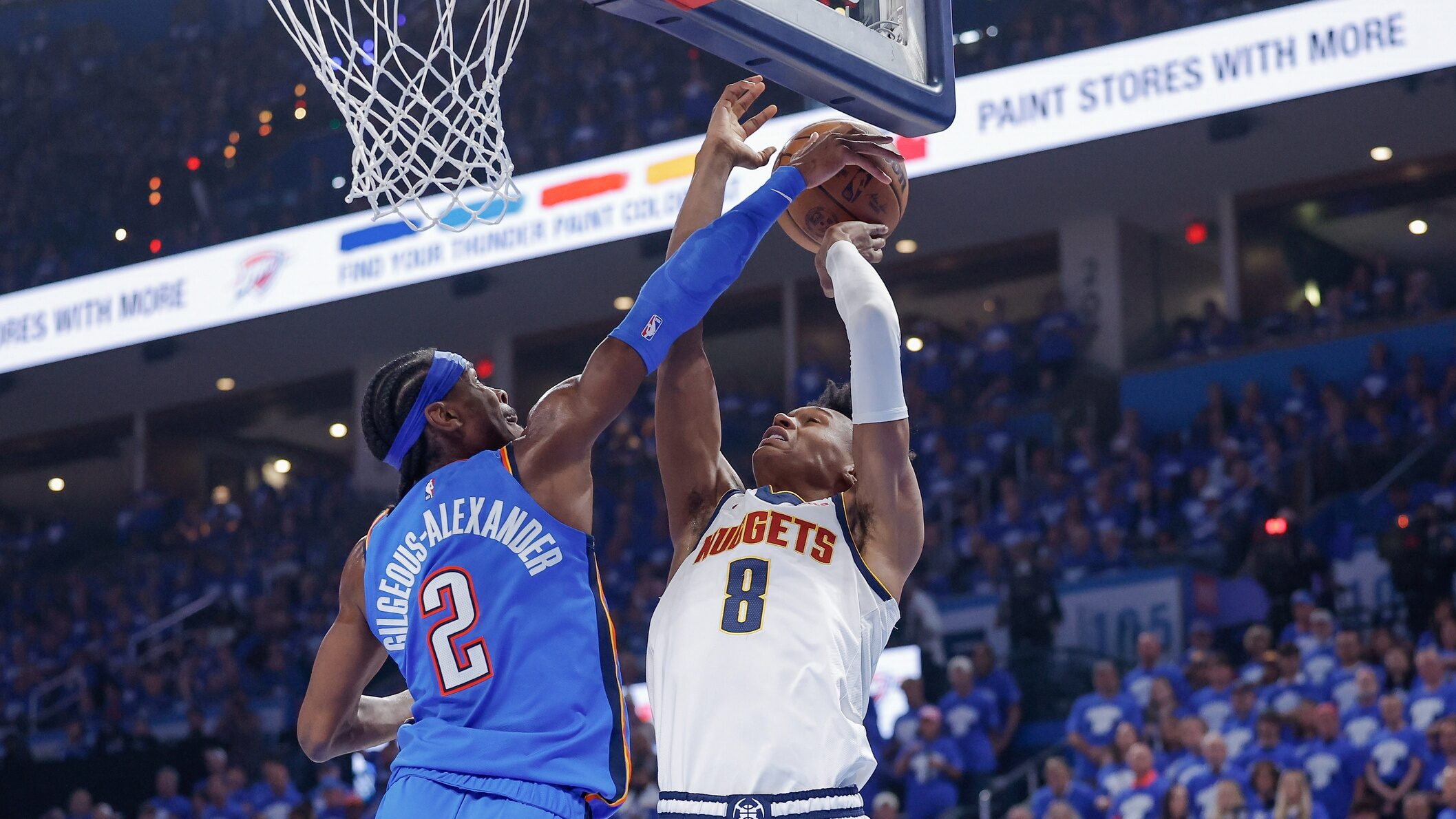 Oklahoma City Thunder guard Shai Gilgeous-Alexander (2) blocks a shot by Denver Nuggets forward Peyton Watson