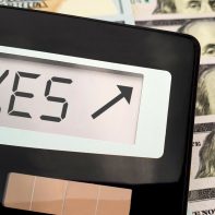 calculator-taxes-up-100-dollar-bills