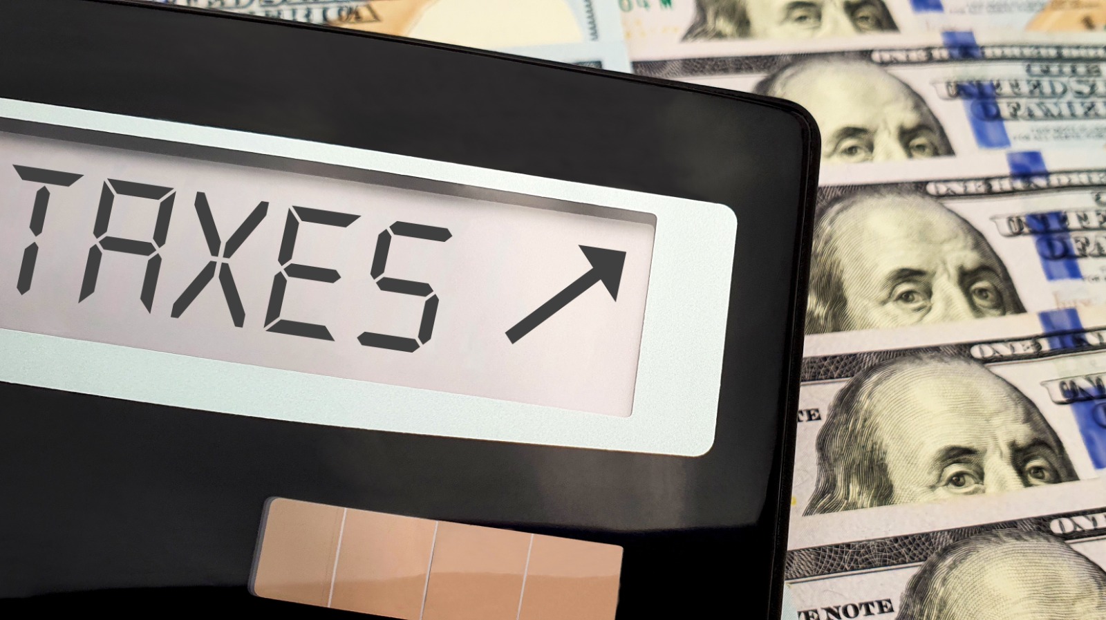 calculator-taxes-up-100-dollar-bills