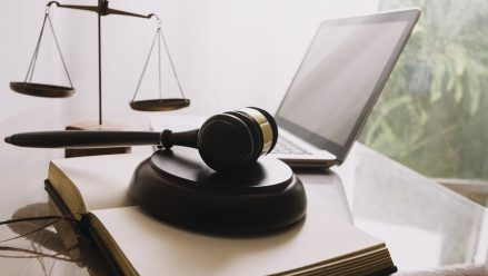 Gavel, scales and laptop © Imagn Images via Vecteezy.com