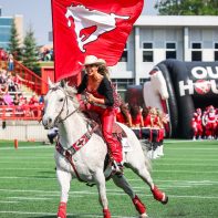woman-riding-horse-flag-calgary-stampede-game